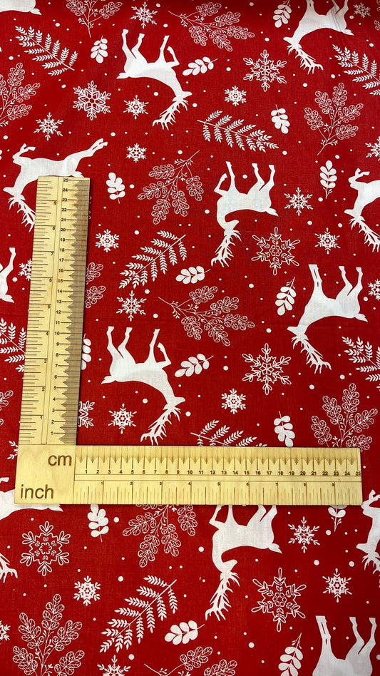 image with 100% cotton fabric - white deer on a red background - available online at Charlotte Fabrics