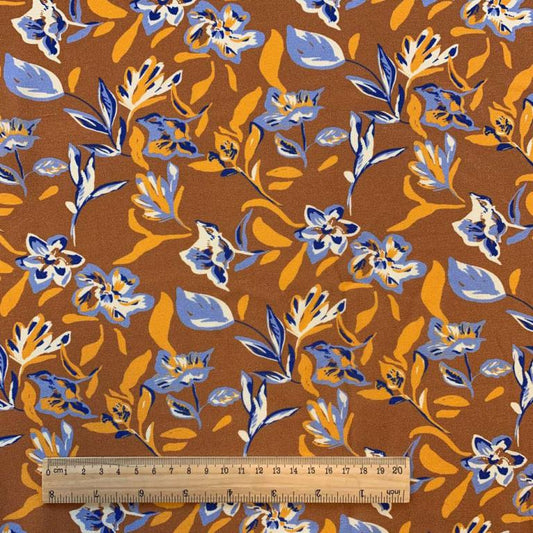 100% Viscose fabric - abstract floral pattern on an orange background 125 g/m²