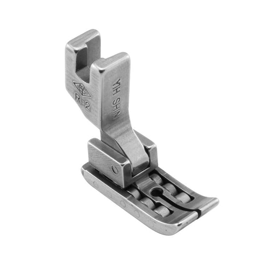 Image of an industrial sewing machine presser foot - roller presser foot – available at Charlotte’s Fabrics