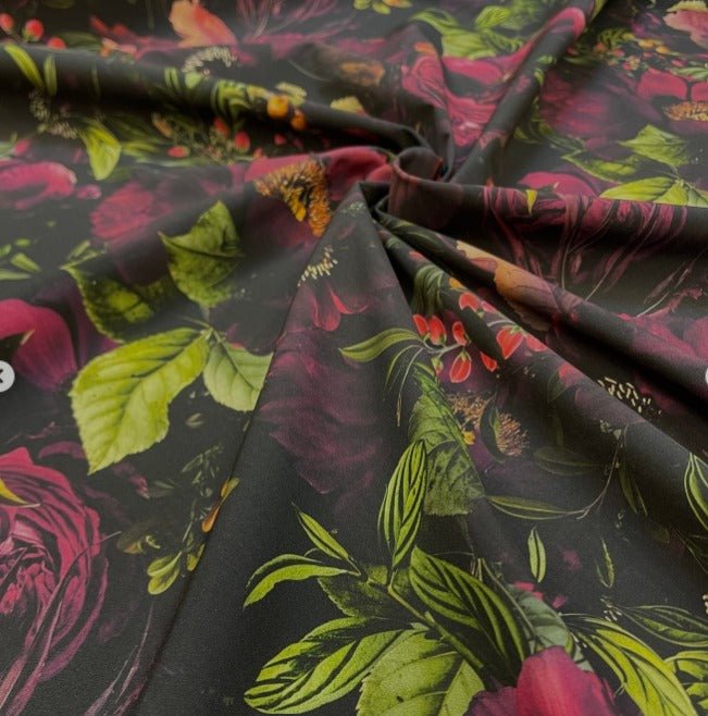 Image of softshell fabric with pink flowers on a dark background – available online at Charlotte's Fabrics