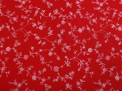 Image du tissu 100 % coton - fleurs blanches sur fond rouge, 125 g/m² – disponible chez Šarlotes audumi