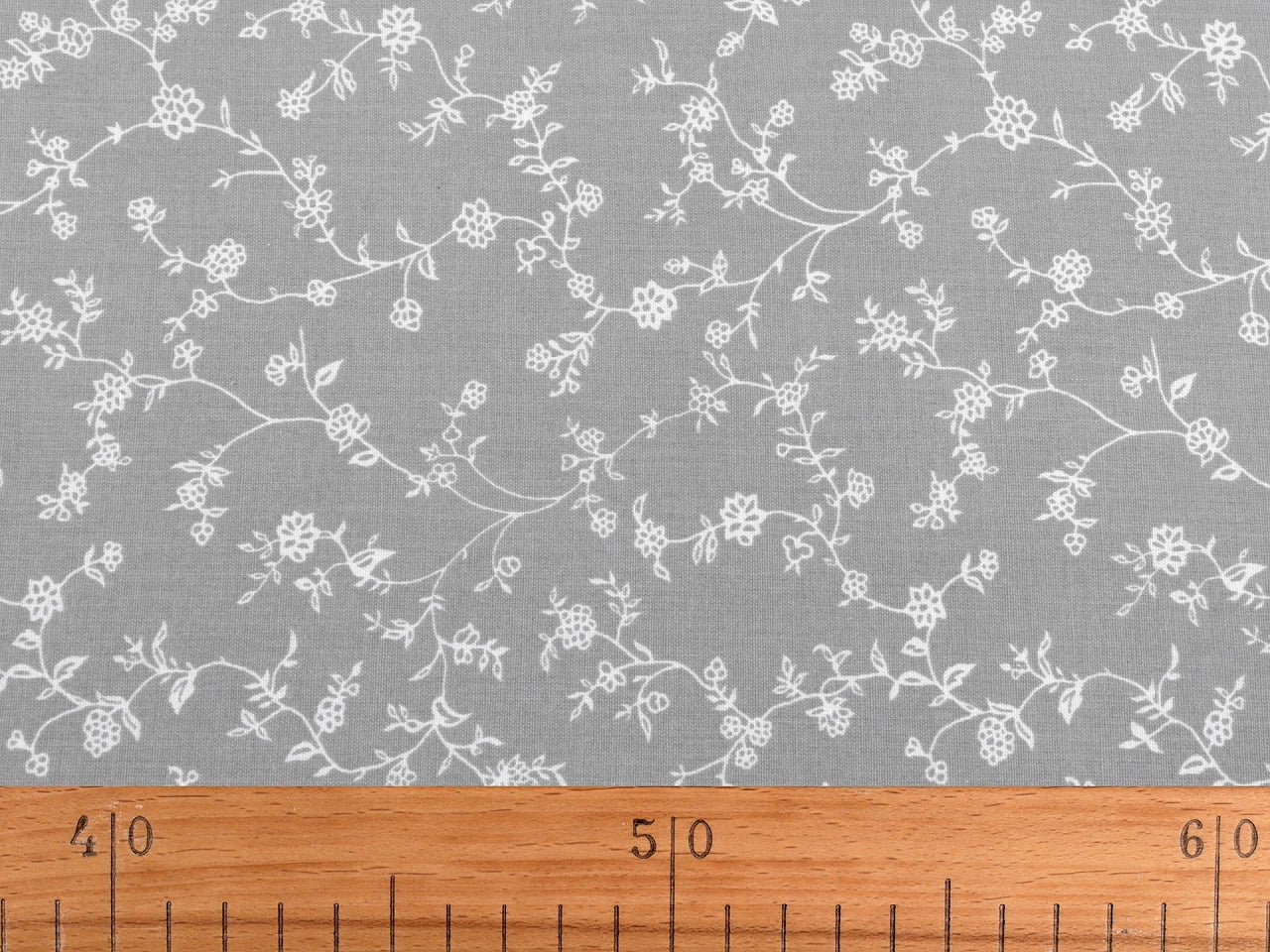 Image with 100% cotton fabric - white floral vines on dark blue 125 g/m² – available at Charlotte Fabrics