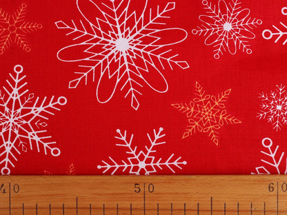 Image of 100% cotton fabric with flakes on red – available online at Šarlotes audumi