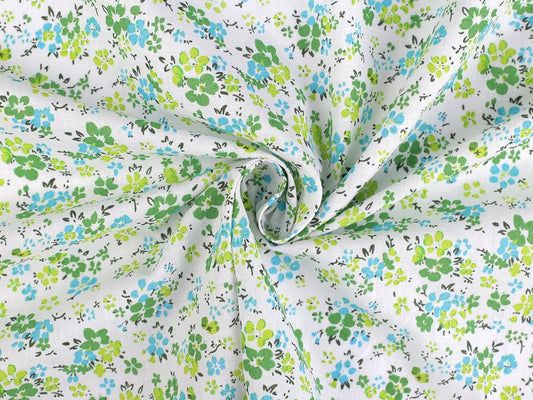 Image of 100% cotton fabric with delicate green flowers – available online at Charlotte's Fabrics