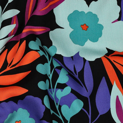 Image of 100% viscose LENZING™ ECOVERO™ fabric with flowers in petrol shades – available online at Šarlotes audumi