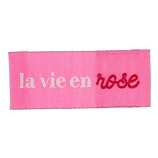 Bohin iešujamas apģērbu etiķetes “La vie en rose” skatīties uz dzīvi caur rozā brillēm– 2 × 5 cm, 4 gab.