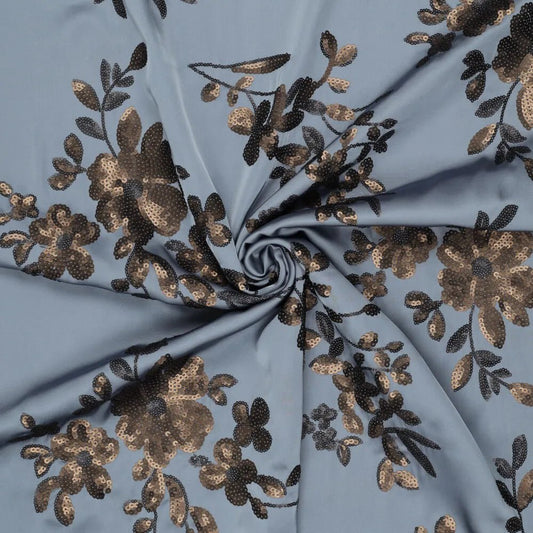 alt
Image of flexible satin fabric with floral embroidery and sequins in blue, black, and gold – available online at Šarlotes audumi