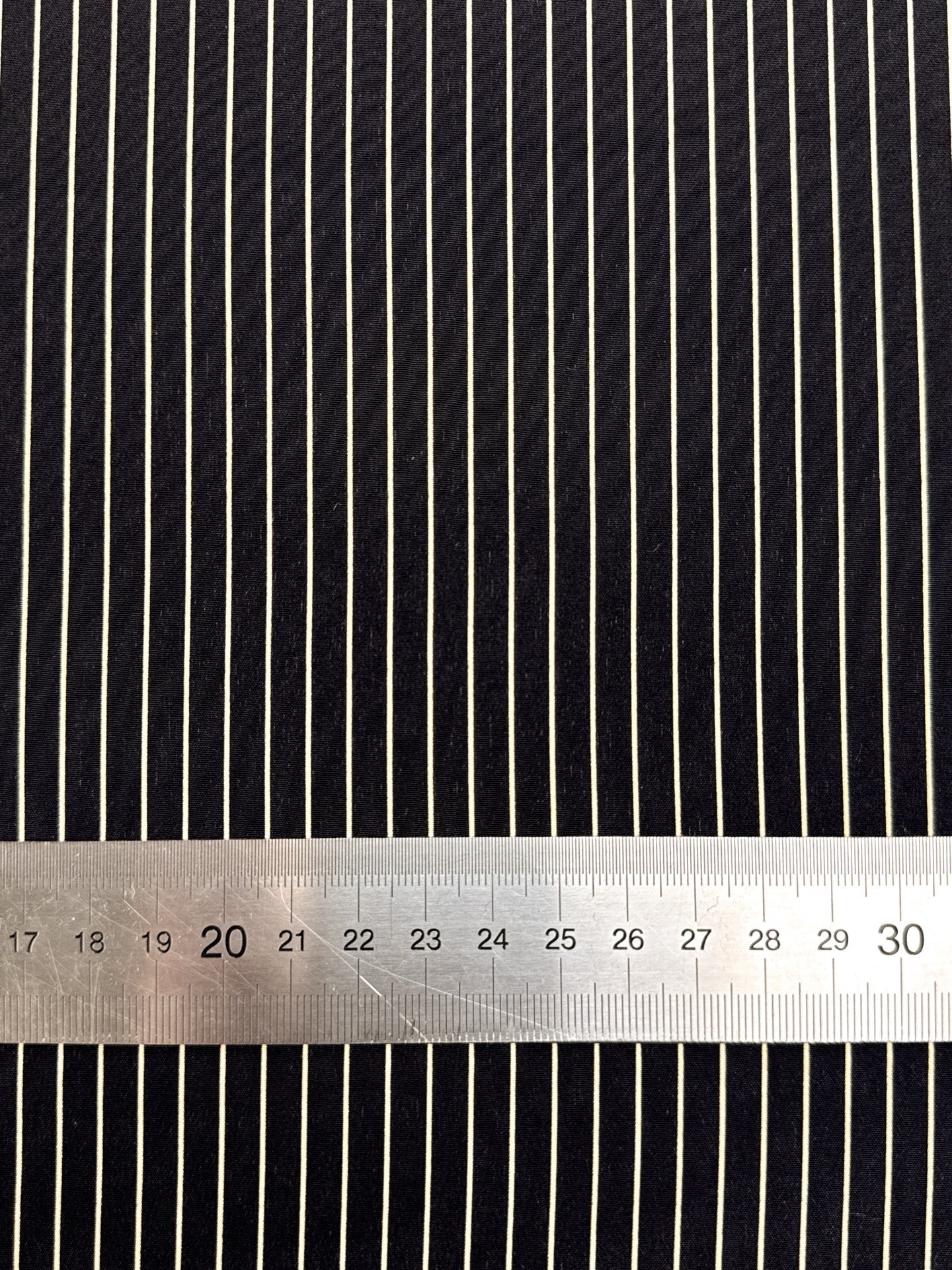 Image of 100% Italian silk fabric with a fine black striped pattern – available online at Charlotte's Fabrics