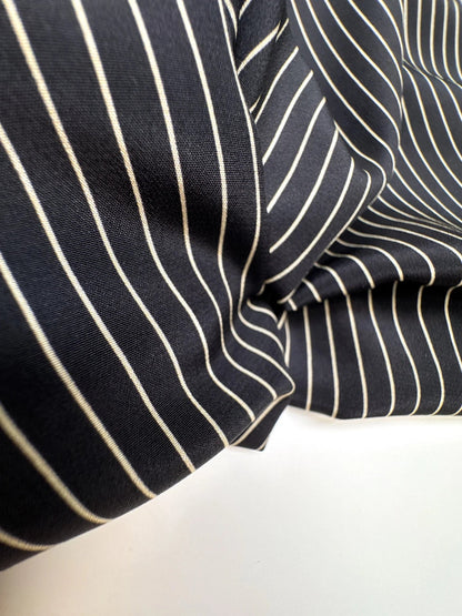 Image of Italian 100% silk fabric with a fine black striped pattern – available online at Charlotte's Fabrics