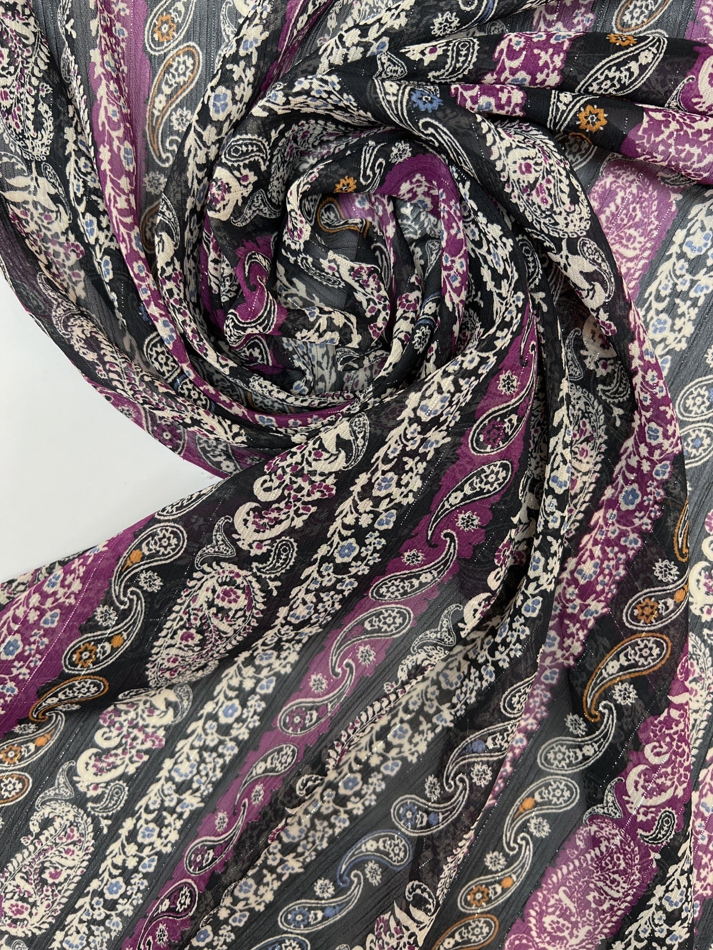 Image of Italian chiffon fabric with a black and purple paisley pattern and lurex thread – available online at Charlotte's Fabrics