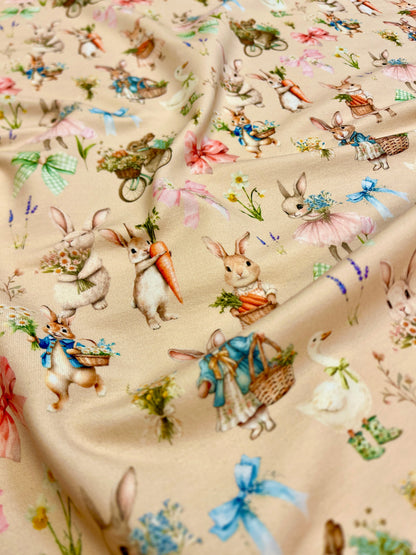 Image of cotton loopback knit - bunnies on a beige background 250 g/m² – available at Šarlotes audumi