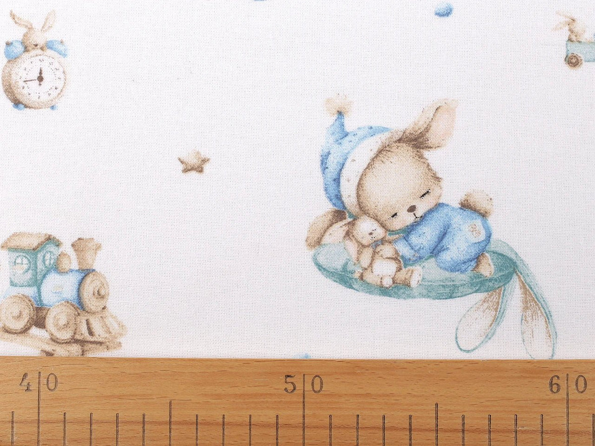 Image of cotton flannel with rabbits in blue accents – available online at Šarlotes audumi