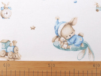 Image of cotton flannel with rabbits in blue accents – available online at Šarlotes audumi