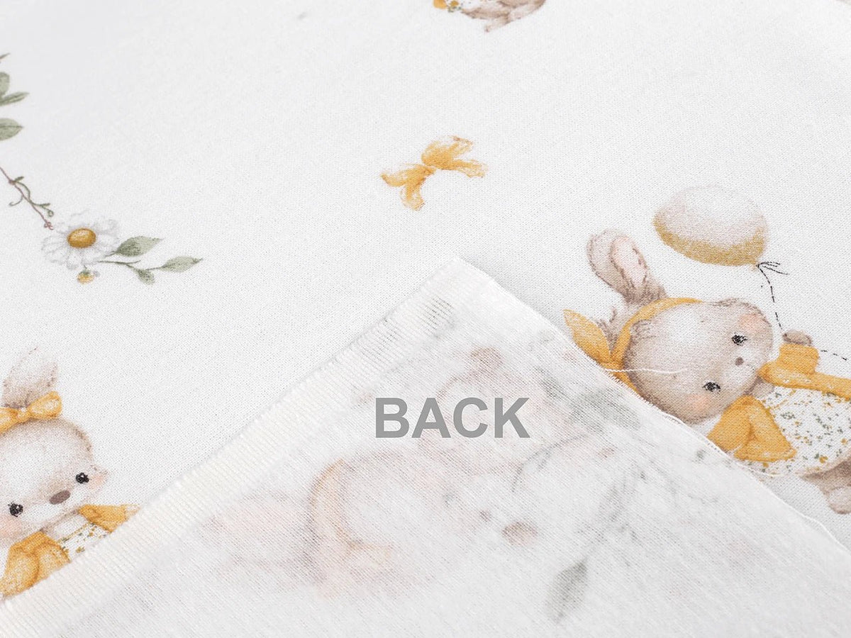 Image of cotton flannel with bunnies in yellow bows – 100% cotton – available online at Šarlotes audumi