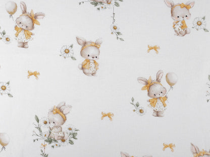 Image of cotton flannel with bunnies in yellow bows – 100% cotton – available online at Šarlotes audumi