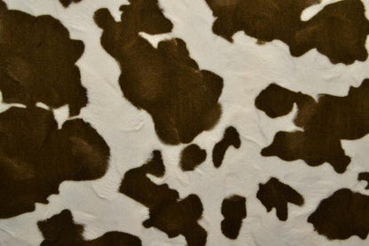 Image of faux fur with cow pattern – brown/white – available online at Charlotte's Fabrics