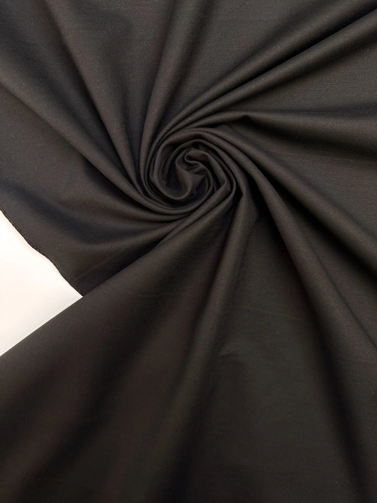 Image with black cotton suit fabric with elastane and moiré effect – Italy – available online at Šarlotes audumi