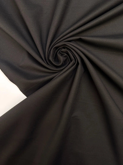 Image with black cotton suit fabric with elastane and moiré effect – Italy – available online at Šarlotes audumi