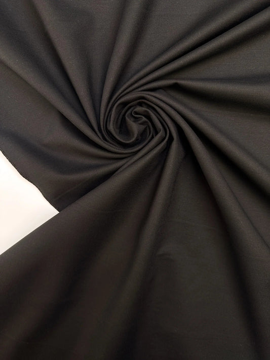 Tissu de costume en coton noir avec élasthanne et effet moiré – Italie – disponible en ligne chez Tissus Charlotte