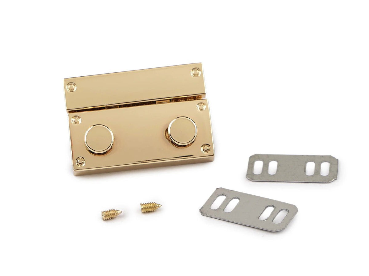 Image of metal bag clasp 27 × 41 mm – available online at Šarlotes audumi