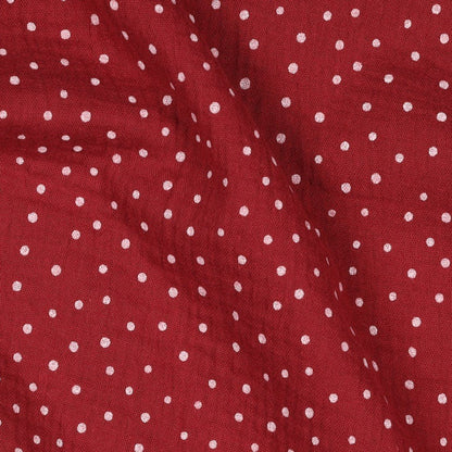 Image of muslin with dots on a dark red background, 125 g/m² – available at Charlotte Fabrics