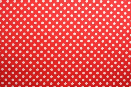 Image of poplin dots on a red background – available online at Šarlotes audumi