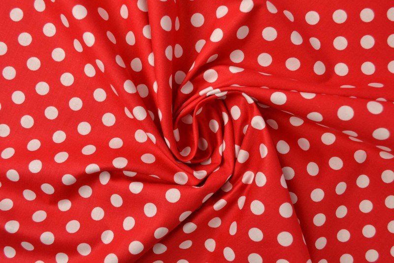 Image of poplin dots on a red background – available online at Šarlotes audumi