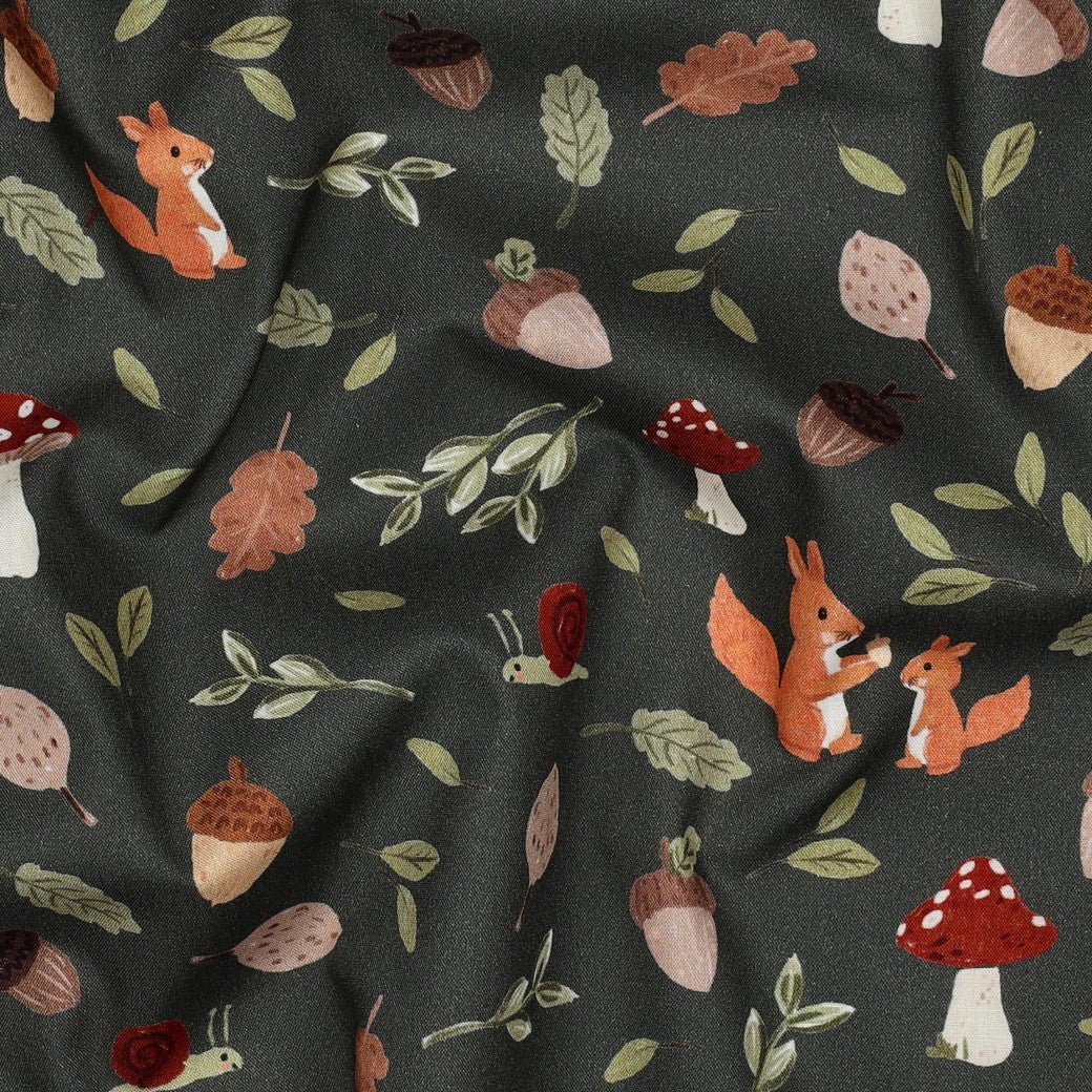 Image of premium 100% cotton fabric with an autumn motif on dark green – available online at Charlotte's Fabrics