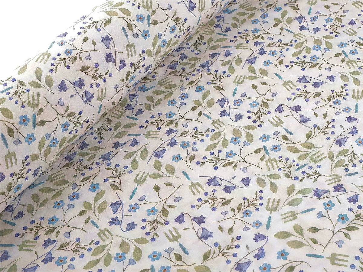 Image of premium lightweight 100% cotton fabric with blue flowers – available online at Charlotte Fabrics