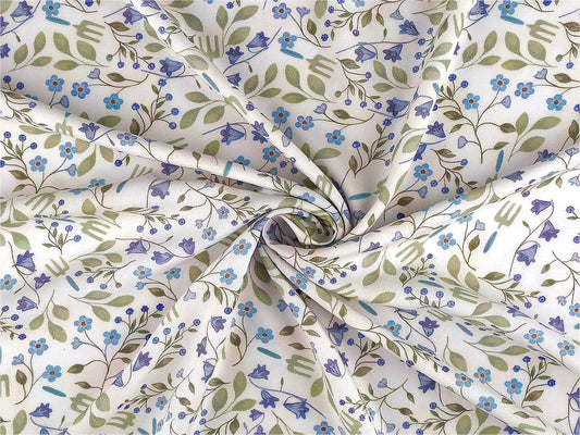 Image of premium lightweight 100% cotton fabric with blue flowers – available online at Charlotte Fabrics