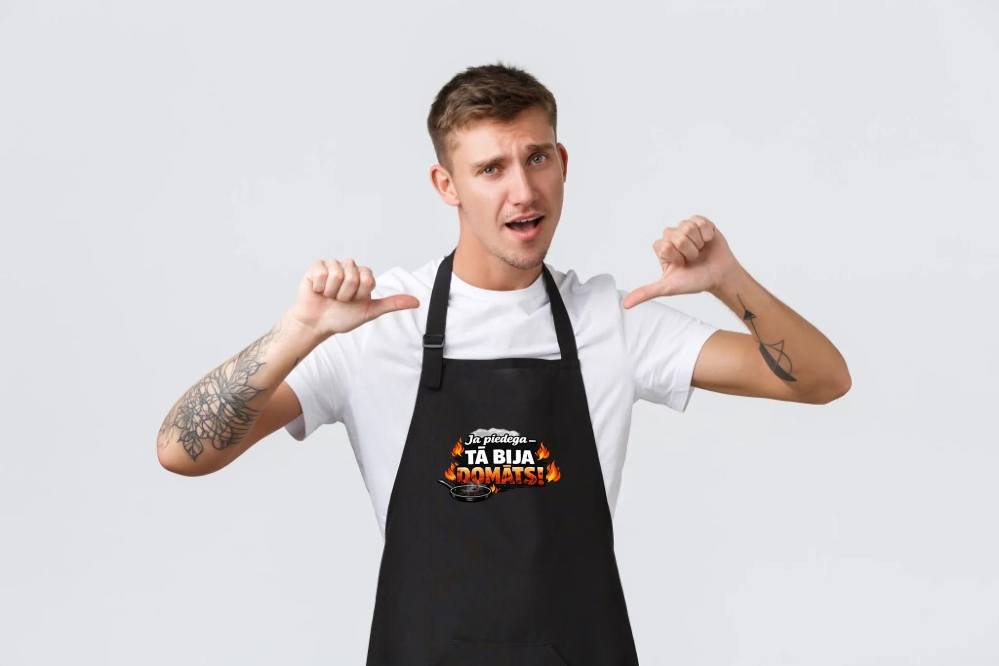 Image of a black apron, "If it burned, it was meant to" – available at Šarlotes audumi