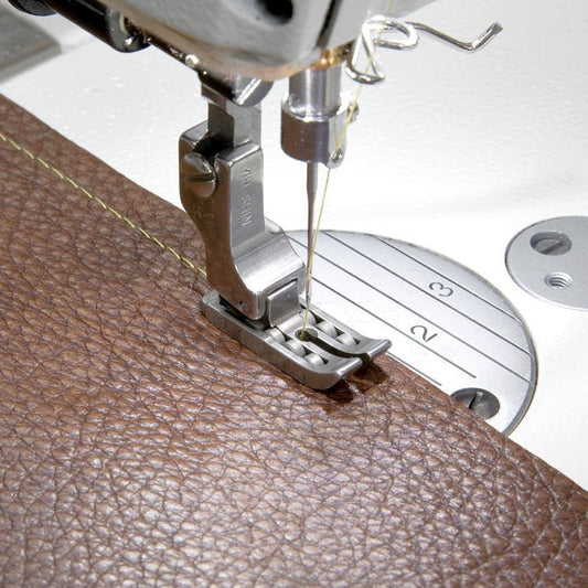 Image of an industrial sewing machine presser foot - roller foot – available at Šarlotes audumi