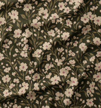 Image of fine cotton corduroy with meadow flowers on a green background – available online at Šarlotes audumi