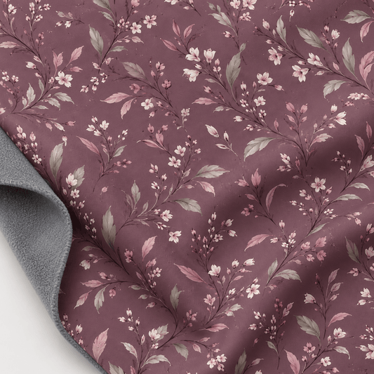 Image of softshell fabric with a floral pattern on a dusty pink background – available online at Šarlotes audumi