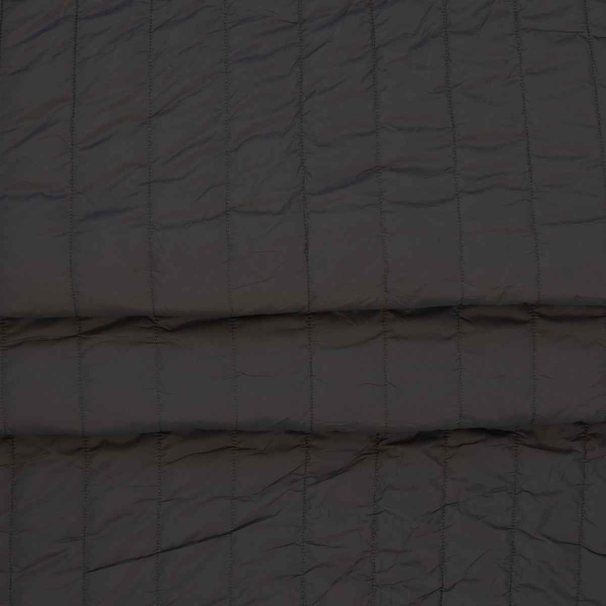 Image of gray quilted fabric with fleece lining – available online at Šarlotes audumi