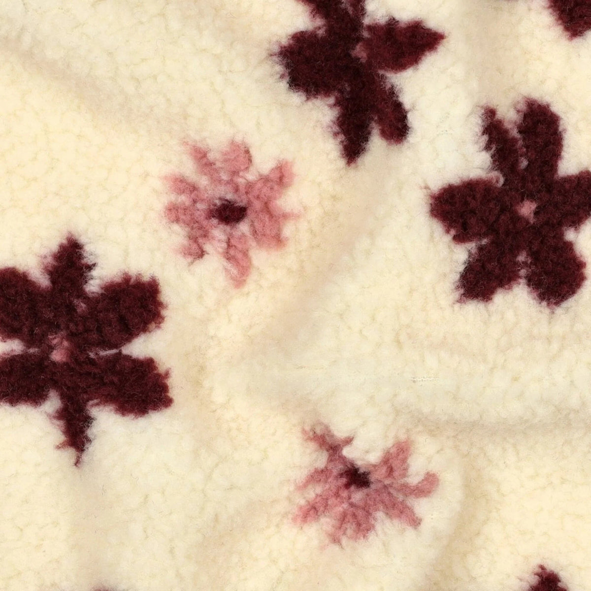 Image with Teddy fleece flowers on a light background – available online at Šarlotes audumi