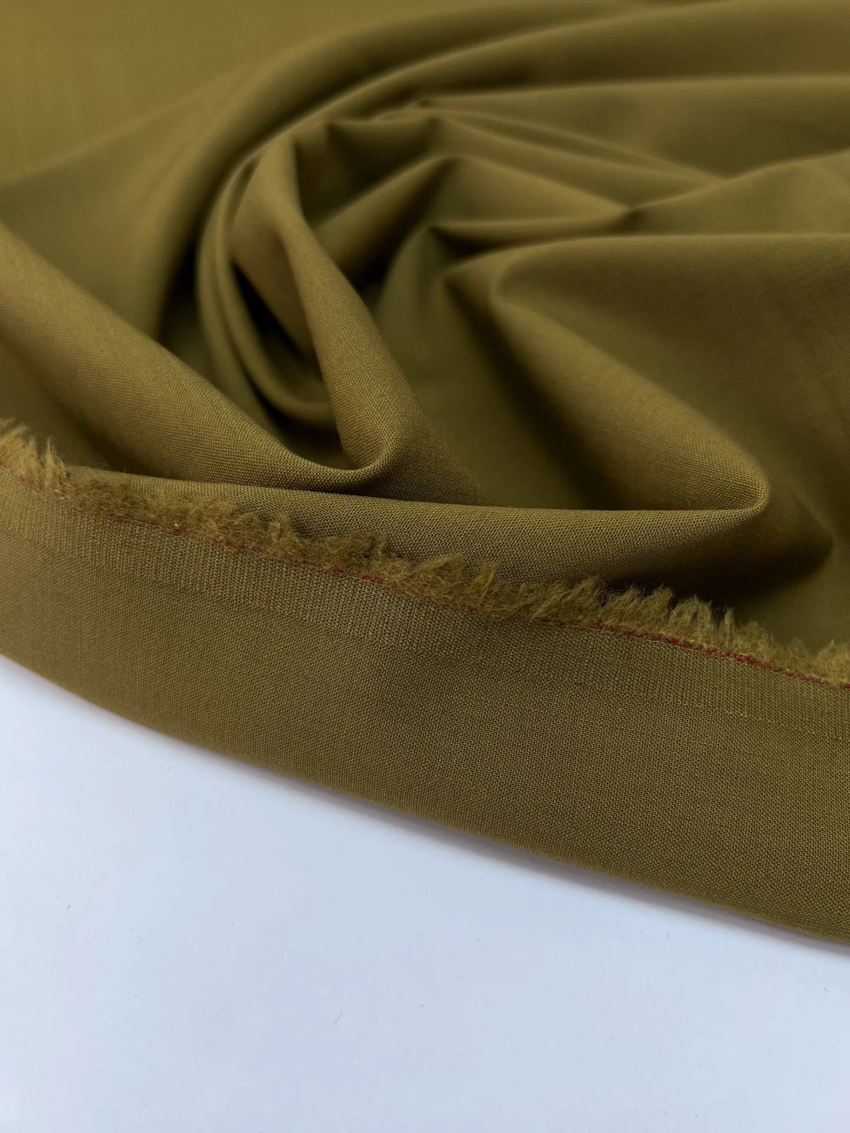 Image of wool fabric with elastane in green-brown – France – available online at Charlotte's Fabrics