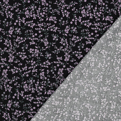 Image of viscose fabric with elastane, delicate floral pattern on black – available online at Šarlotes audumi