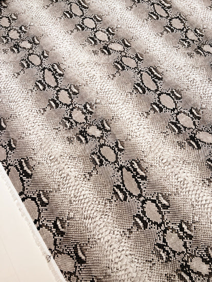 Image of viscose crepe fabric with snakeskin pattern in beige tones – Italy – available online at Šarlotes audumi