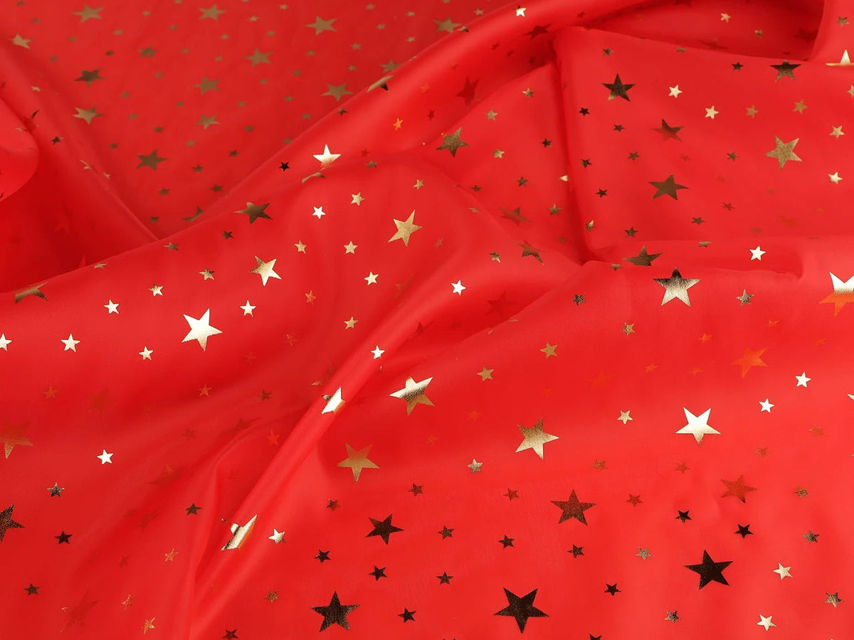 Image of Christmas decorative fabric with gold stars – available online at Šarlotes audumi