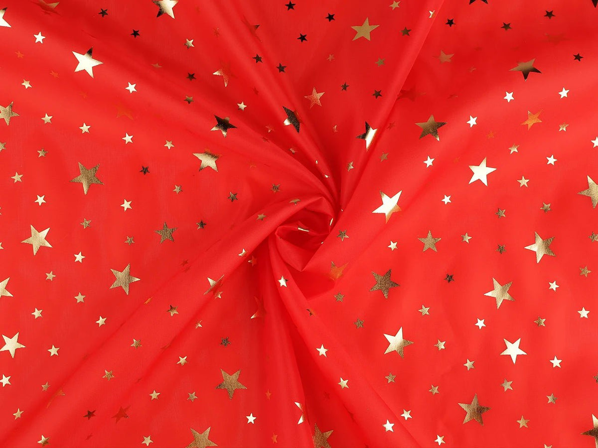 Image of Christmas decorative fabric with gold stars – available online at Šarlotes audumi