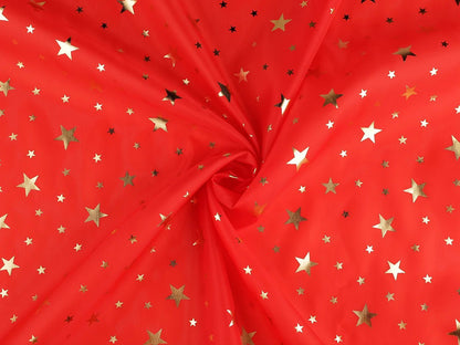 Image of Christmas decorative fabric with gold stars – available online at Šarlotes audumi