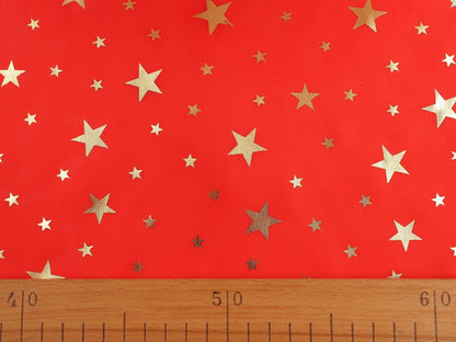 Image of Christmas decorative fabric with gold stars – available online at Šarlotes audumi