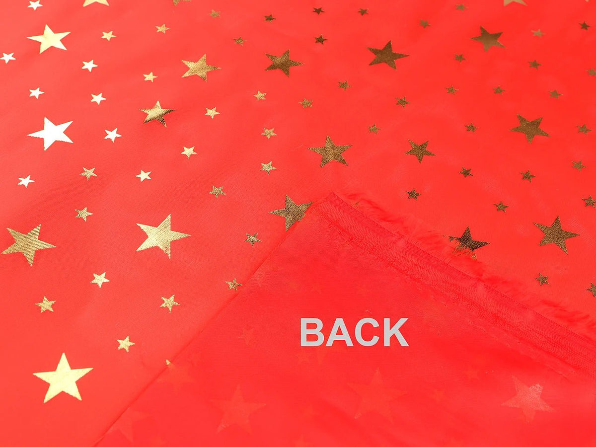Image of Christmas decorative fabric with gold stars – available online at Šarlotes audumi