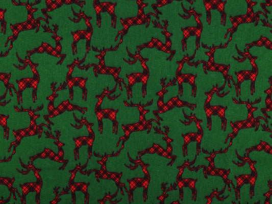 Christmas cotton flannel with reindeer on green – available online at Charlotte's Fabrics